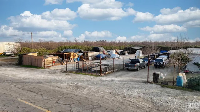 a front view of a house with a garden and plants