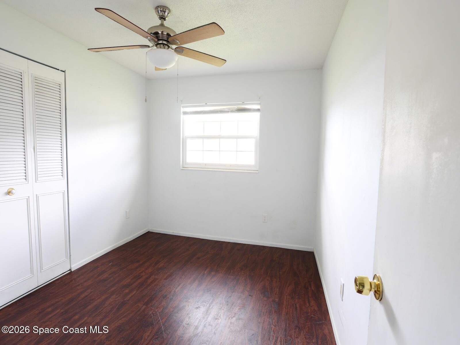 2375 Ricky Road Melbourne, FL 32935 - Photo 22 of 41 an empty room with wooden floor and fan