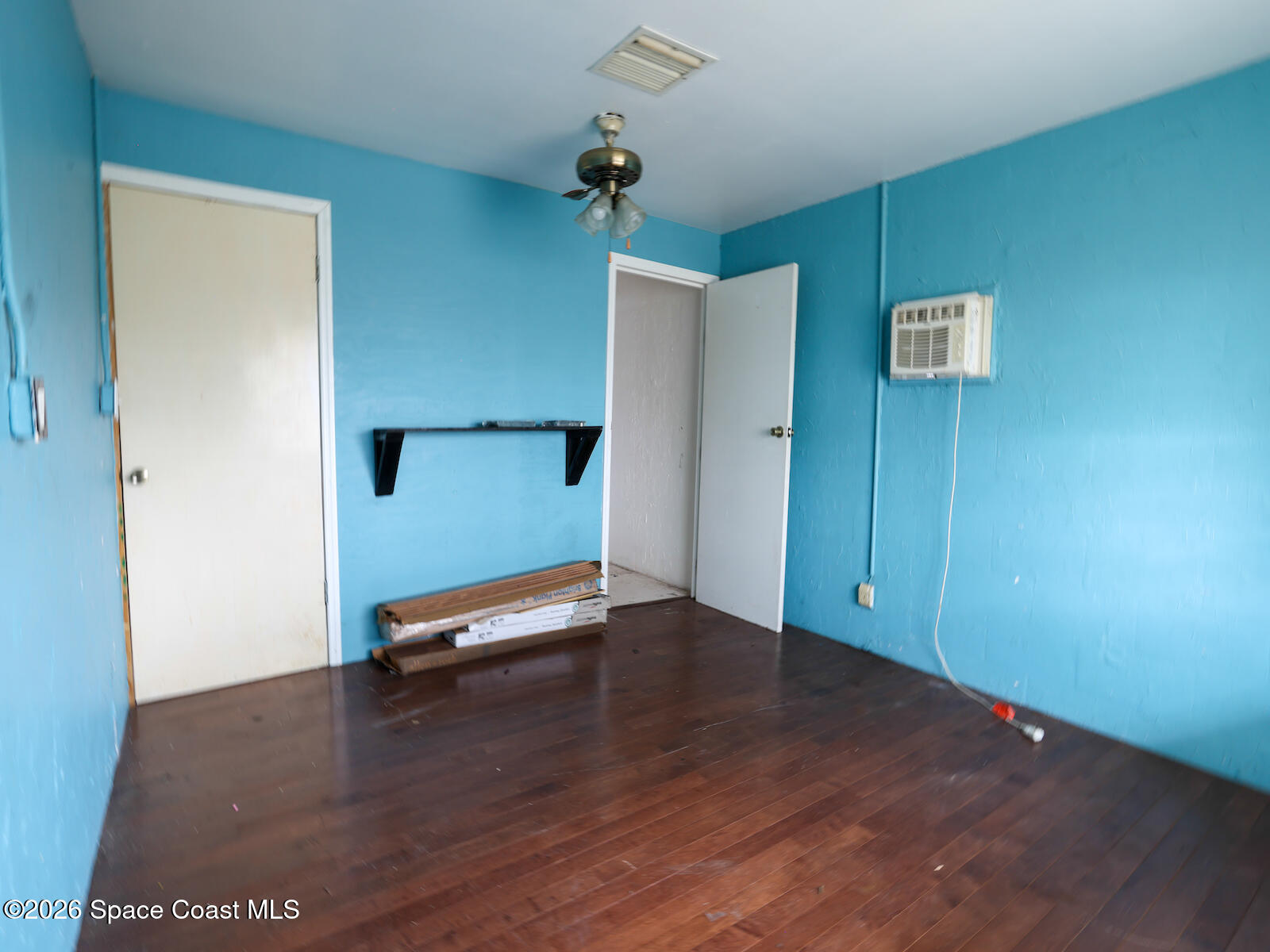 2375 Ricky Road Melbourne, FL 32935 - Photo 34 of 41 a view of a room with wooden floor and ceiling fan