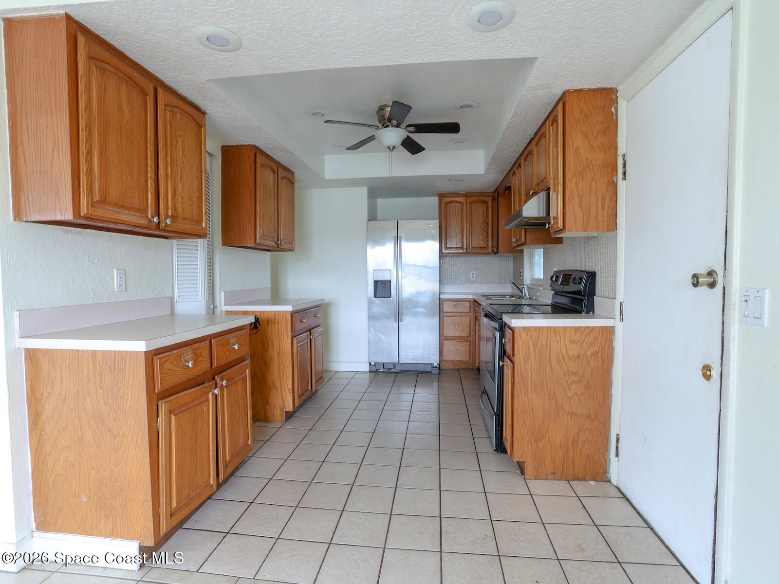 2375 Ricky Road Melbourne, FL 32935 - Photo 5 of 41 a kitchen with stainless steel appliances granite countertop a refrigerator and a stove top oven