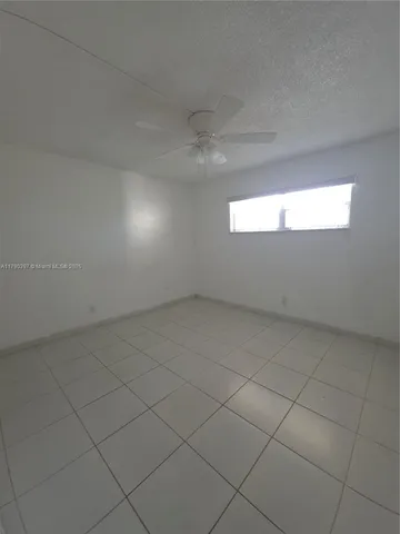 an empty room with a empty space and windows