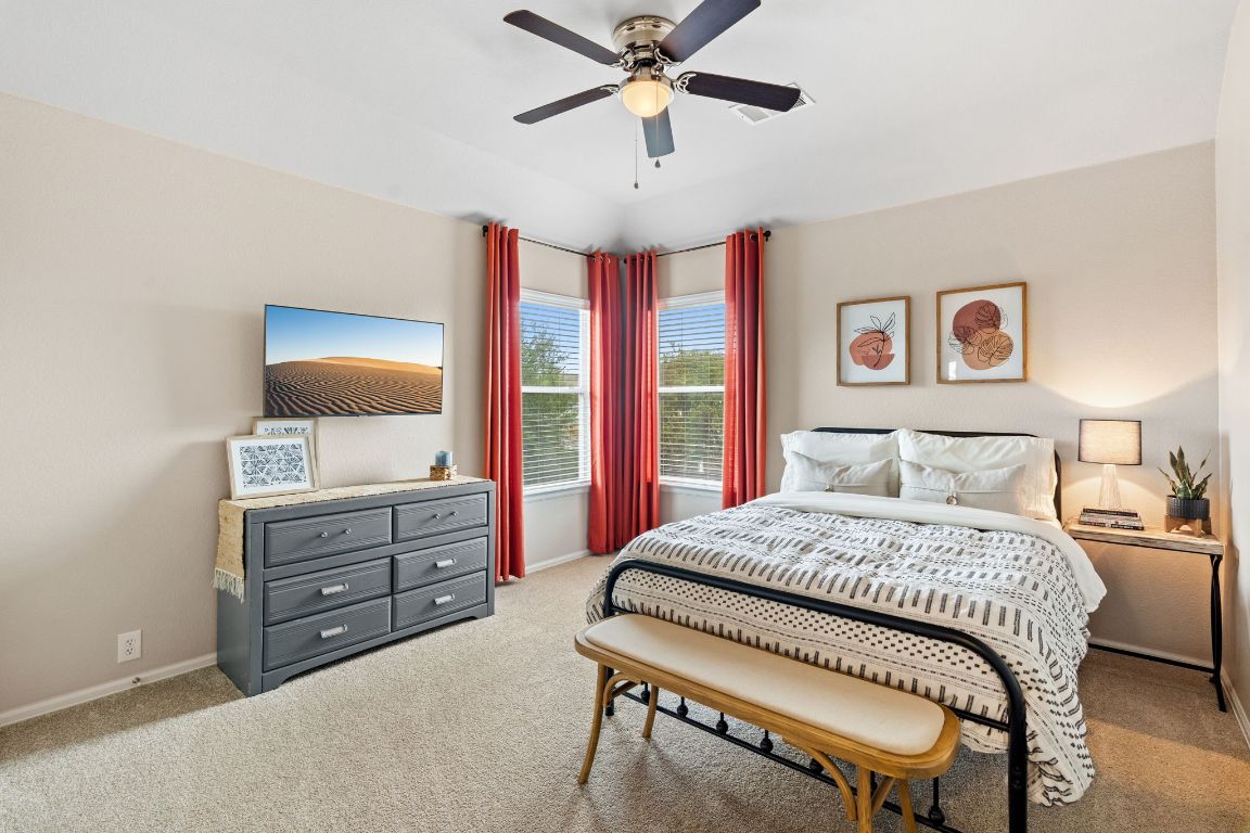 154 Larch Cove Kyle, TX 78640 - Photo 17 of 25 a bedroom with a bed and a dresser