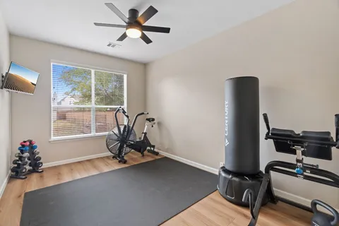 a view of a workspace with furniture and a window