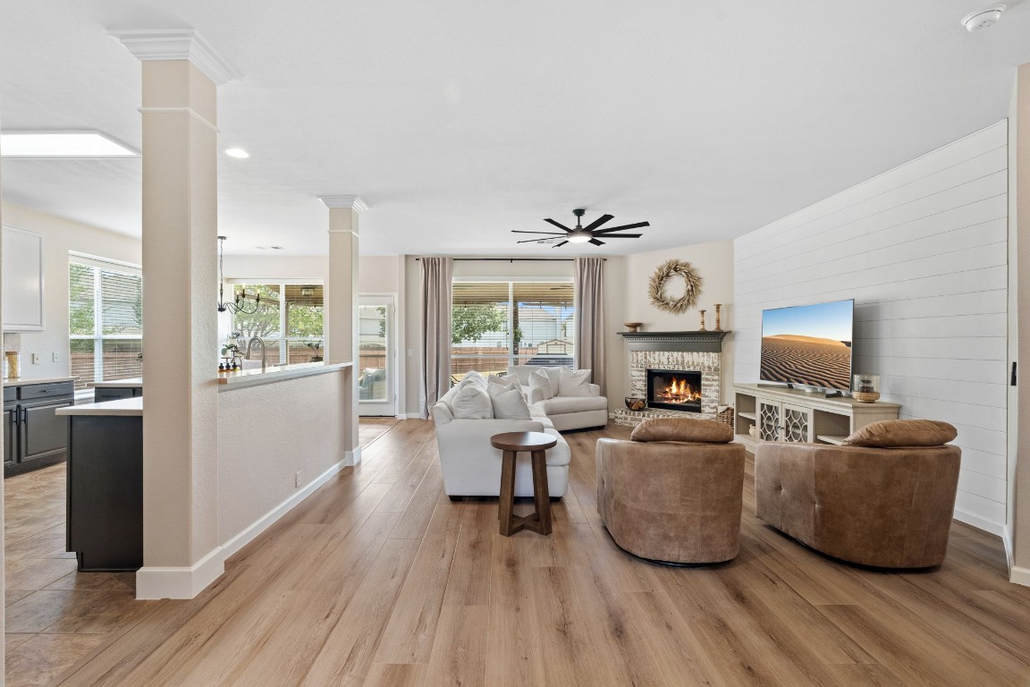 154 Larch Cove Kyle, TX 78640 - Photo 3 of 25 a living room with fireplace furniture and a wooden floor