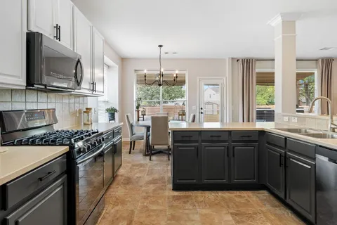a kitchen with a sink stove and microwave