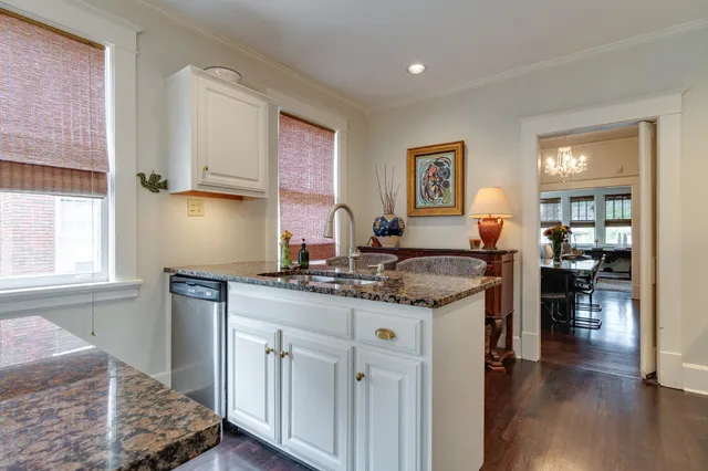 a kitchen with a sink cabinets and wooden floor