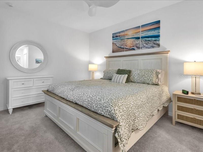19116 Scallop Loop, Unit 303 Lakewood Ranch, FL 34211 - Photo 22 of 32 a bedroom with a bed and a dresser