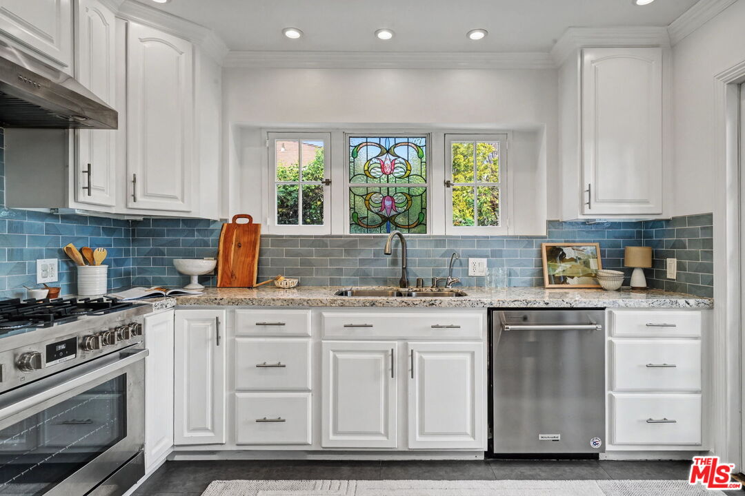 5009 Willowcrest Avenue North Hollywood, CA 91601 - Photo 15 of 61 a kitchen with stainless steel appliances granite countertop a stove a sink and white cabinets