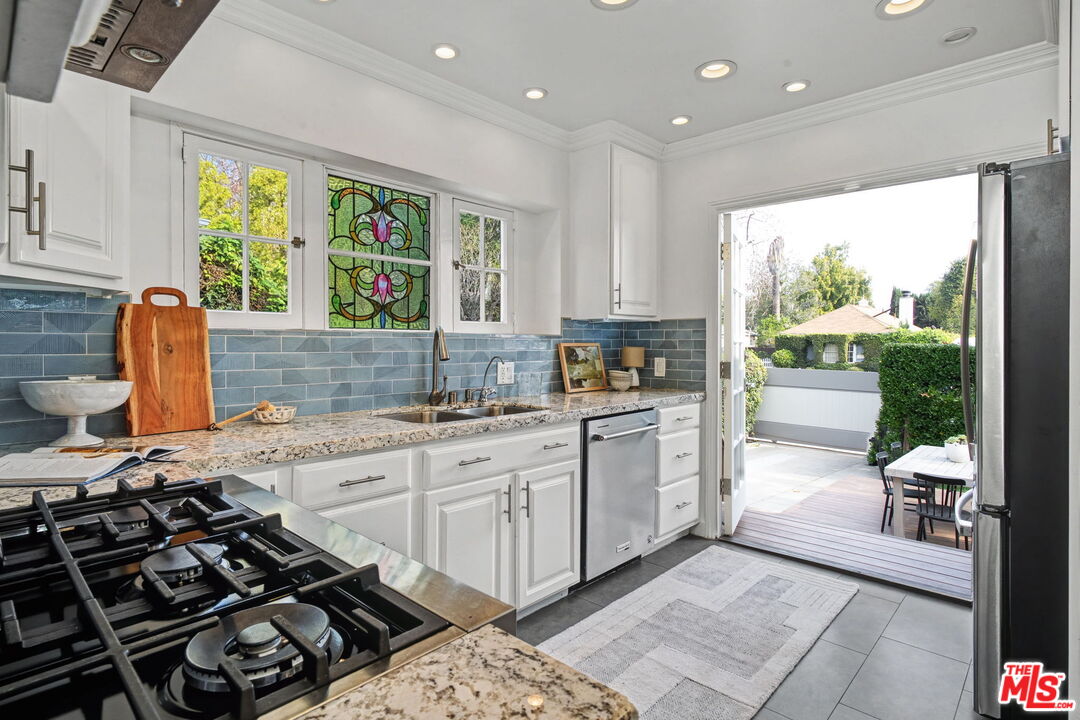 5009 Willowcrest Avenue North Hollywood, CA 91601 - Photo 17 of 61 a kitchen with a sink appliances cabinets and a large window