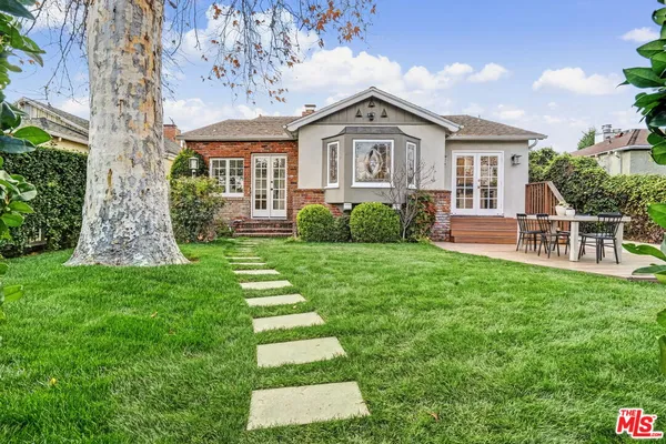 a front view of a house with a garden