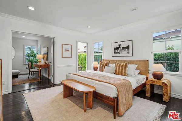 a living room with furniture a rug and a large window