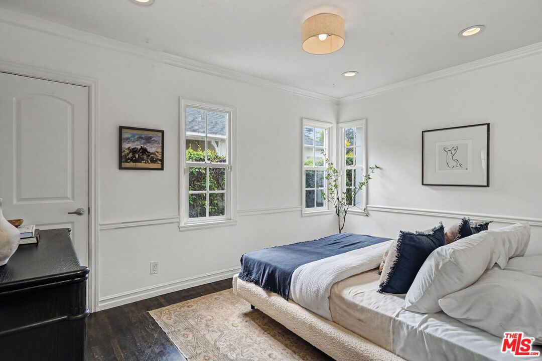 5009 Willowcrest Avenue North Hollywood, CA 91601 - Photo 37 of 61 a bedroom with a bed and wooden floor