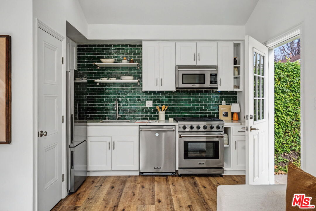 5009 Willowcrest Avenue North Hollywood, CA 91601 - Photo 56 of 61 a kitchen with granite countertop a stove and a microwave