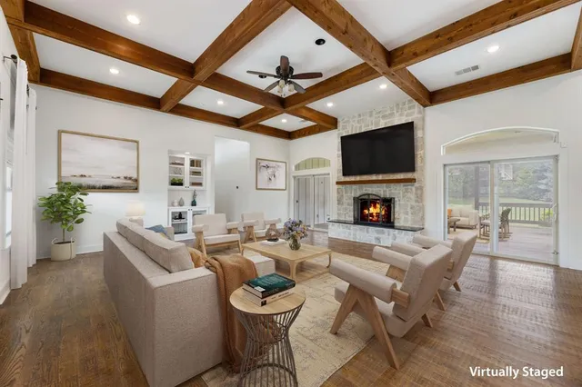 a view of empty room with wooden floor and fireplace