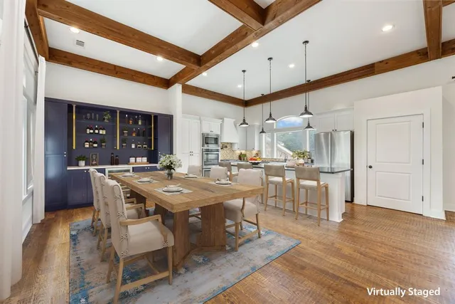 a view of a kitchen with refrigerator and white cabinets