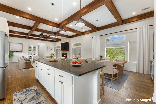 a kitchen with granite countertop white cabinets and stainless steel appliances