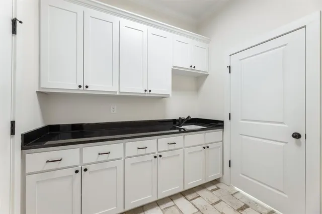 a utility room with sink dryer and washer