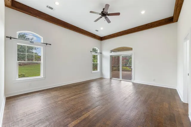 a kitchen with granite countertop white cabinets and sink