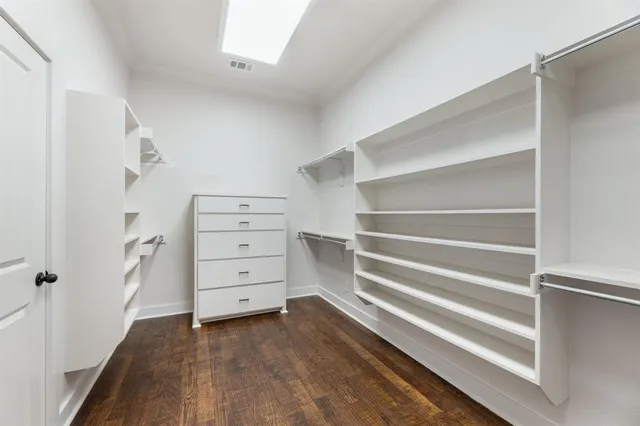 a view of walk in closet with empty racks