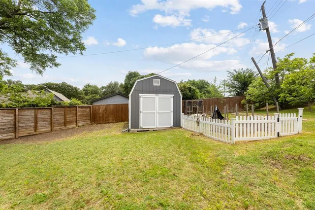 a view of a fountain with a table and chairs under an umbrella