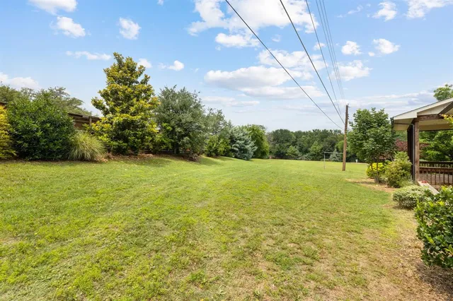 a view of a outdoor space with a garden and deck