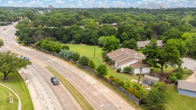 a view of yard with lake and trees in the background
