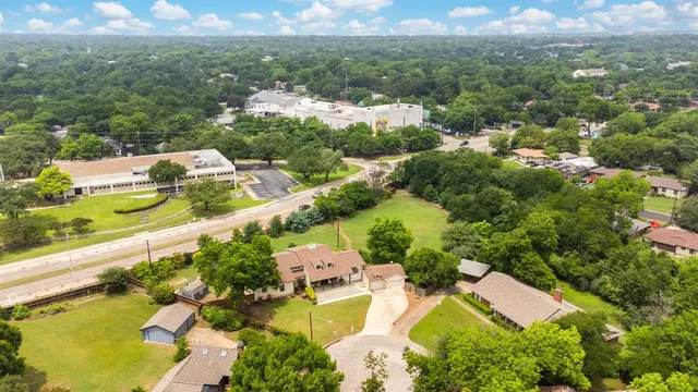 an aerial view of residential houses with outdoor space and street view