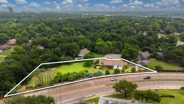 a view of a yard with a wooden fence