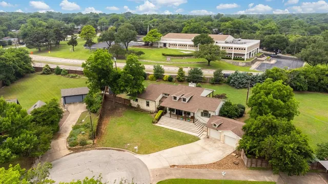 an aerial view of a house with yard swimming pool and outdoor seating