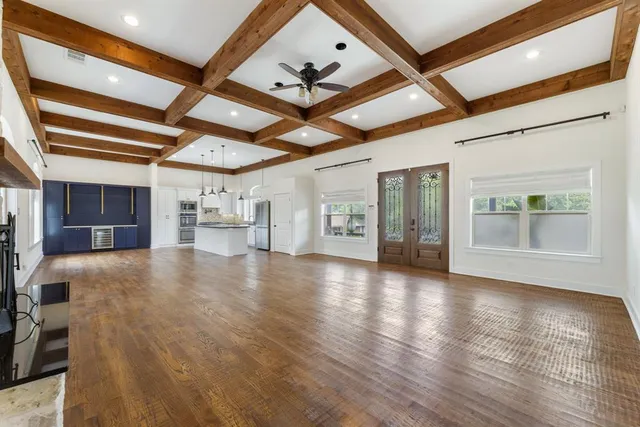 a view of an empty room with a window and fireplace