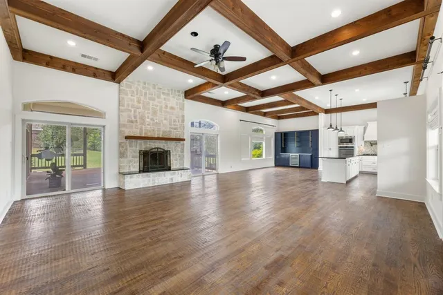 an aerial view of residential houses with outdoor space and trees