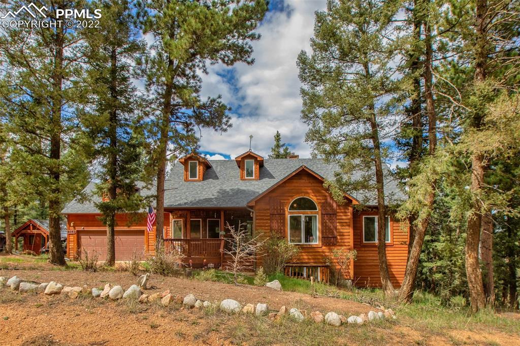 4053 Omer Lane Divide, CO 80814 - Photo 1 of 45 a front view of a house with garden