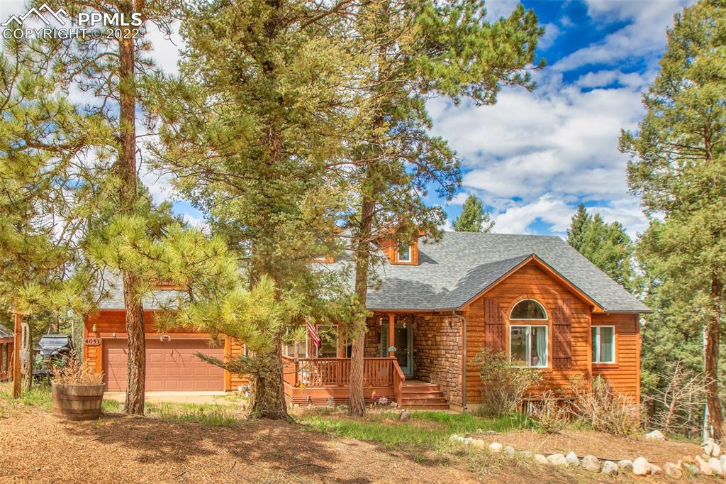 4053 Omer Lane Divide, CO 80814 - Photo 2 of 45 a front view of a house with a yard and garage