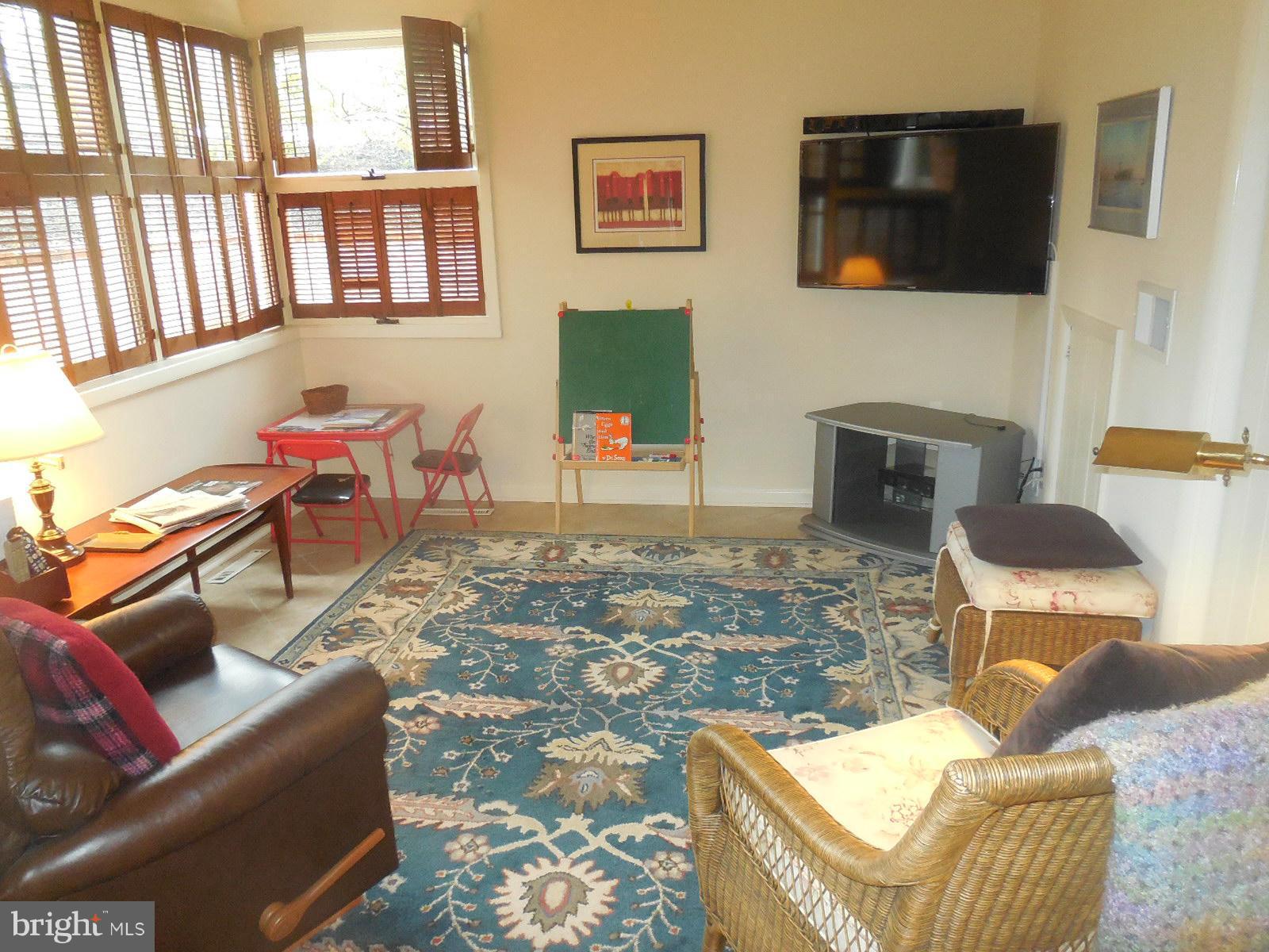 1908 Norvale Road Silver Spring, MD 20906 - Photo 24 of 30 a living room with furniture a flat screen tv and a fireplace