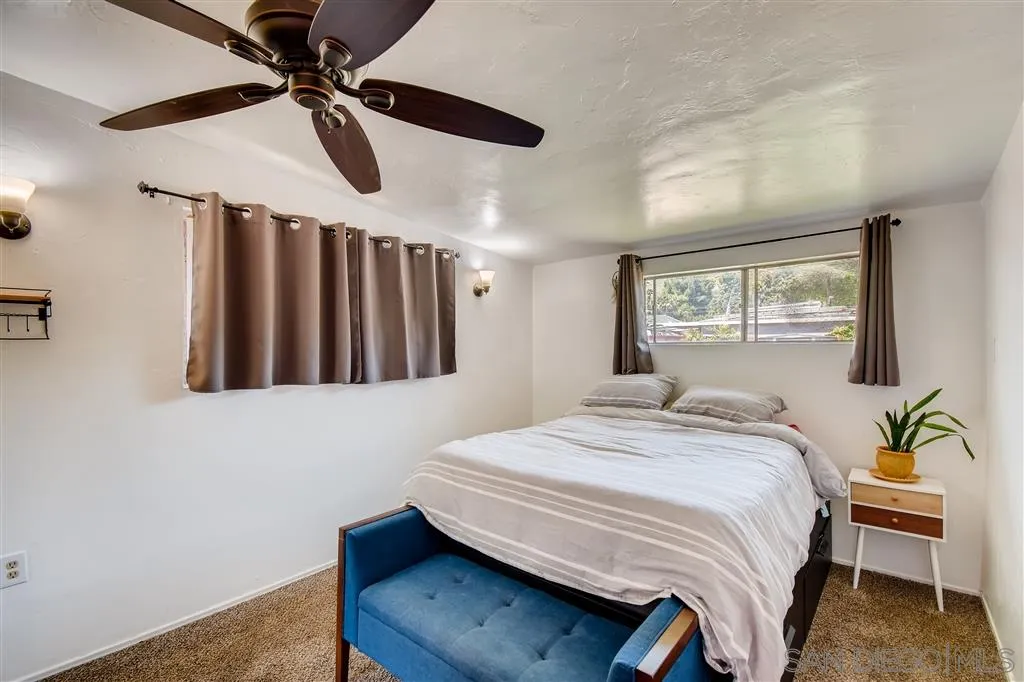 8236 Linden Road Lakeside, CA 92040 - Photo 5 of 12 a bedroom with a large bed chandelier and a window