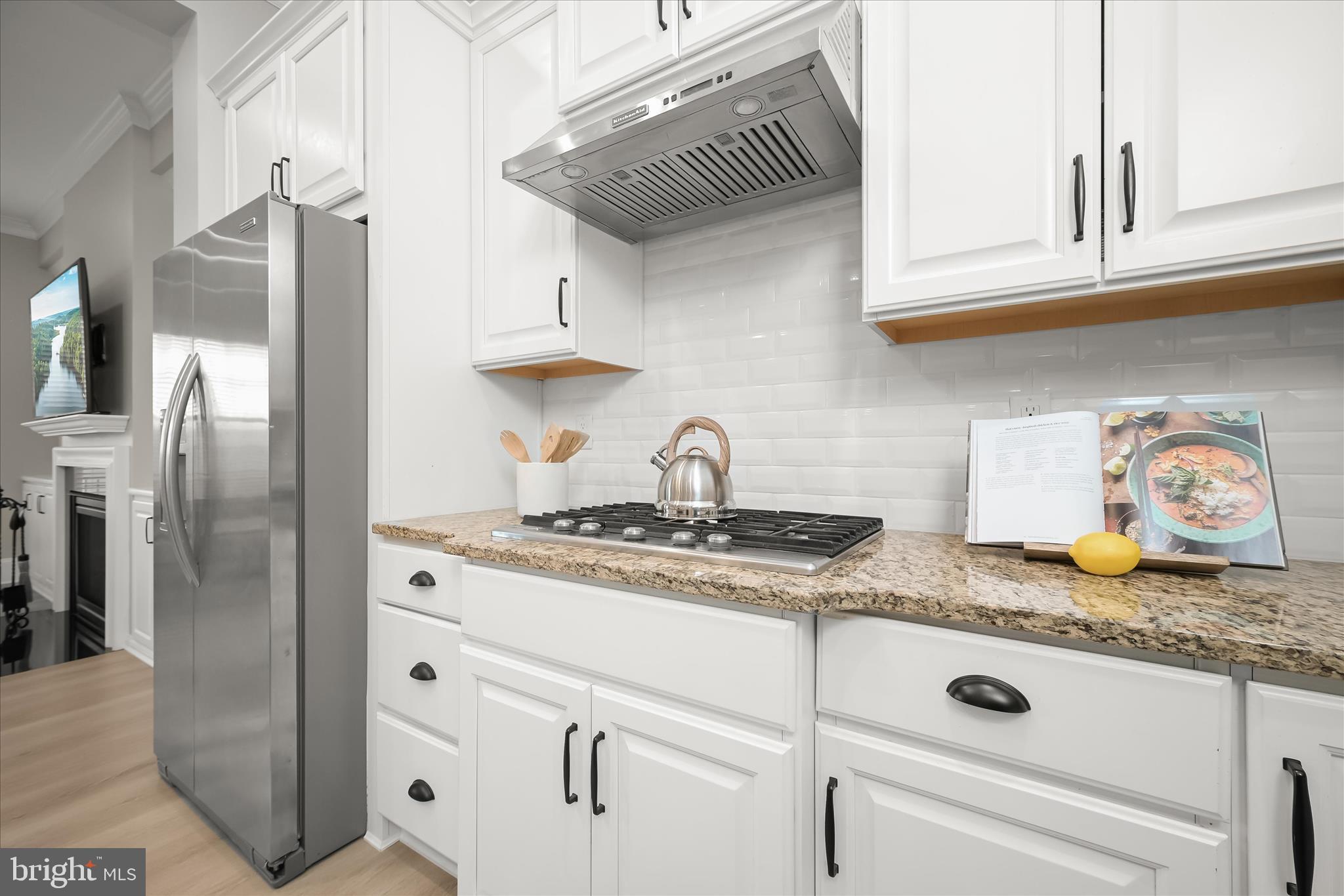 7905 Maple Lawn Boulevard Fulton, MD 20723 - Photo 11 of 49 a kitchen with granite countertop white cabinets and stainless steel appliances