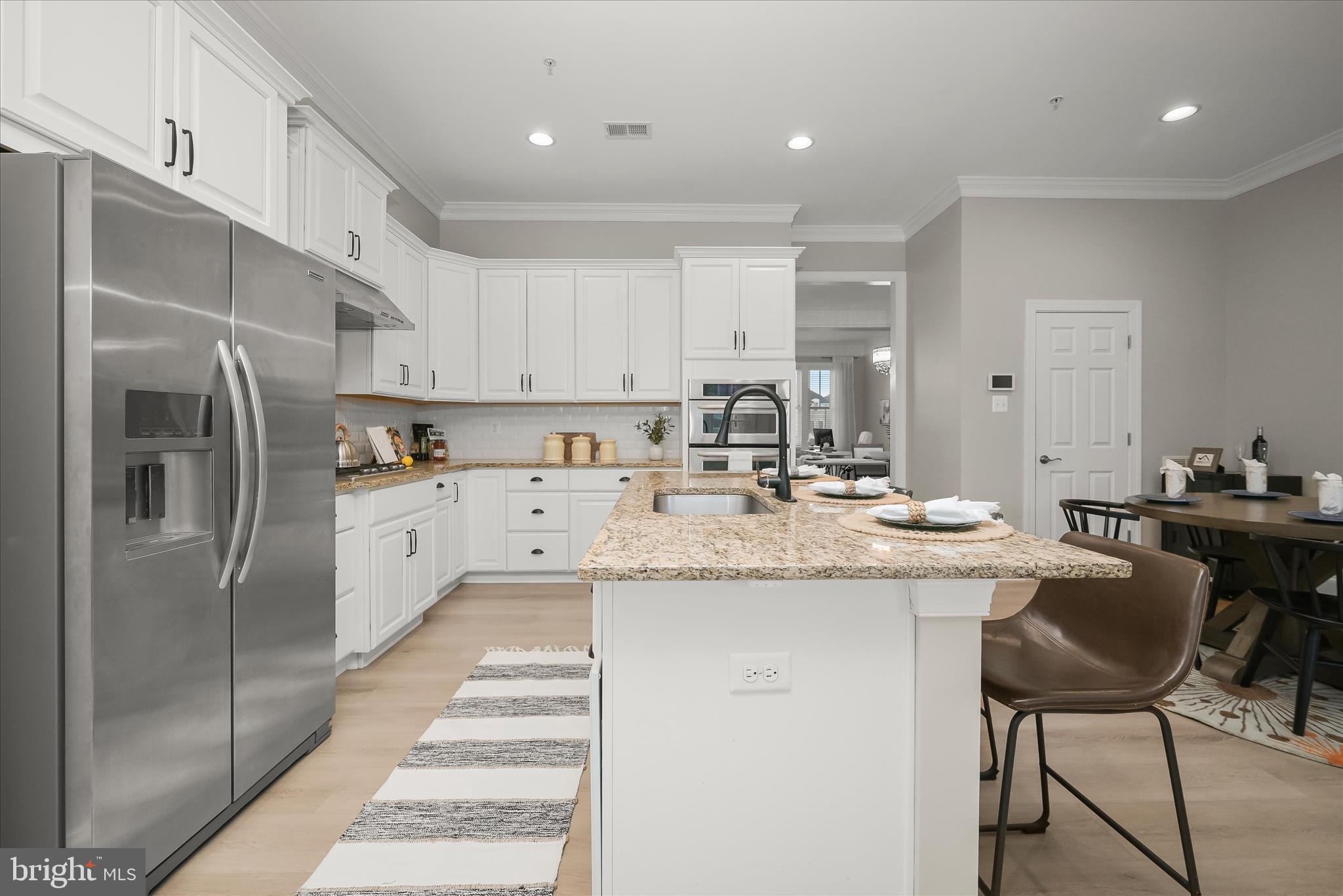 7905 Maple Lawn Boulevard Fulton, MD 20723 - Photo 12 of 49 a kitchen with stainless steel appliances kitchen island granite countertop a sink and cabinets