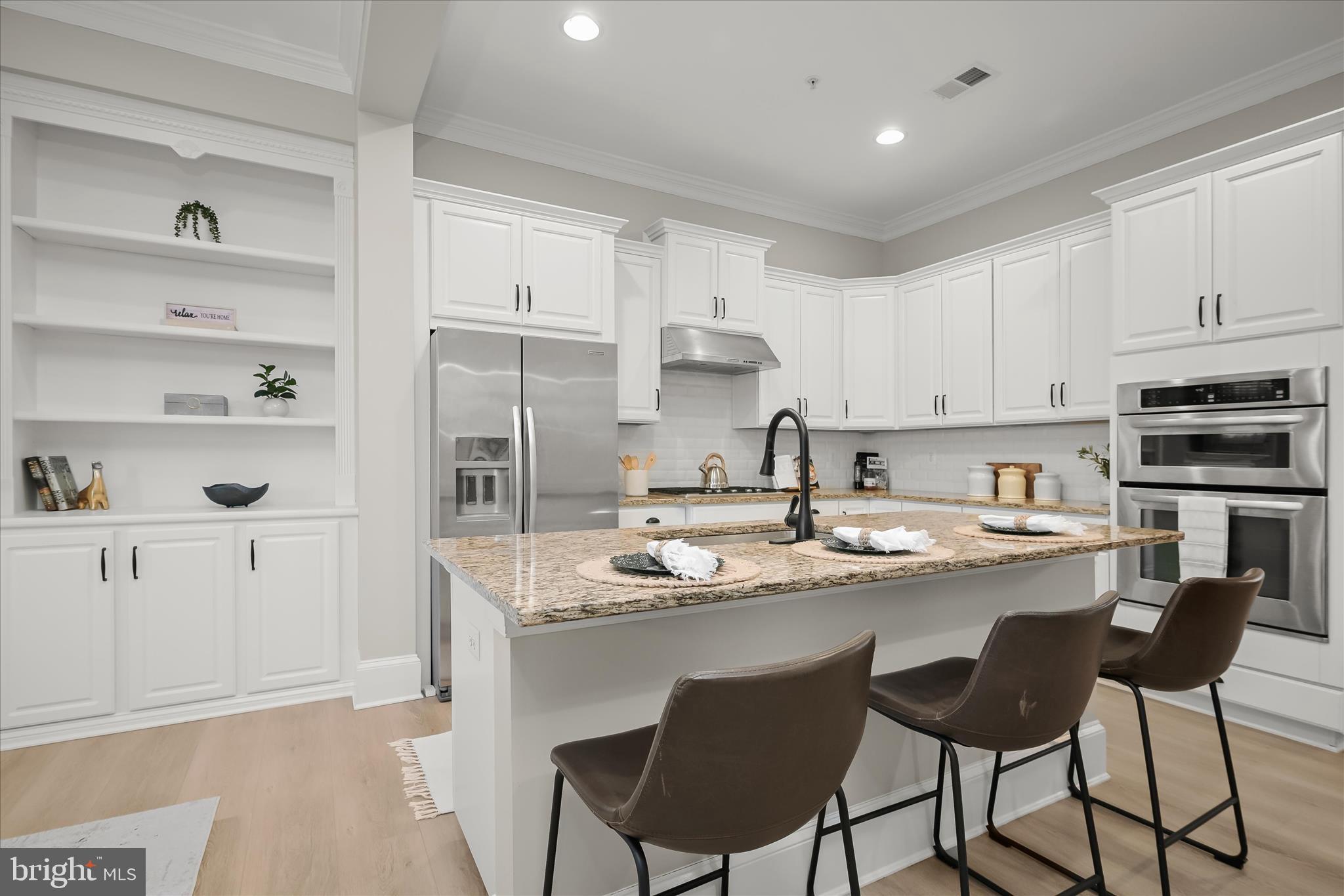 7905 Maple Lawn Boulevard Fulton, MD 20723 - Photo 13 of 49 a kitchen with stainless steel appliances granite countertop a sink and cabinets