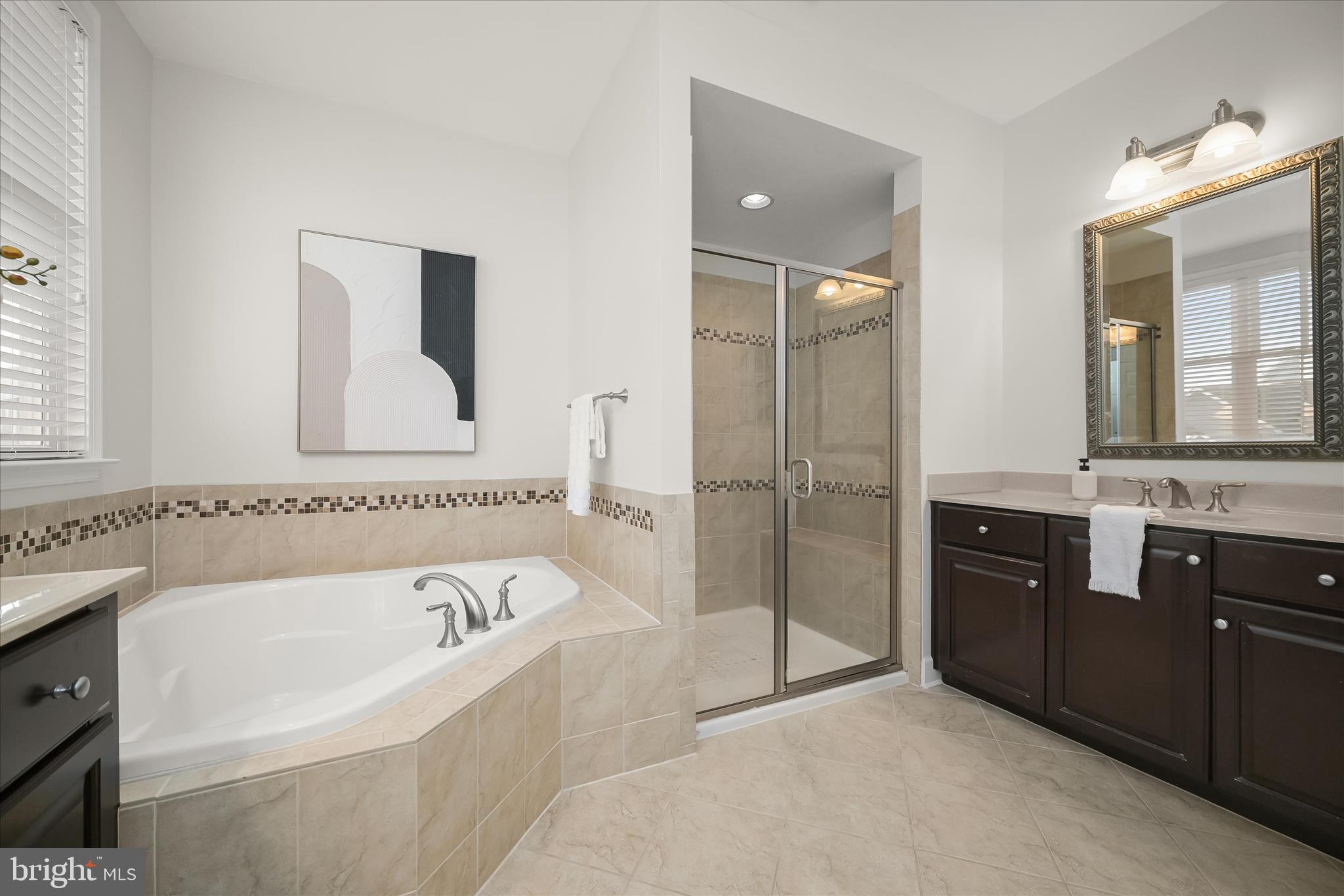 7905 Maple Lawn Boulevard Fulton, MD 20723 - Photo 23 of 49 a bathroom with a bathtub and a double vanity sink mirror
