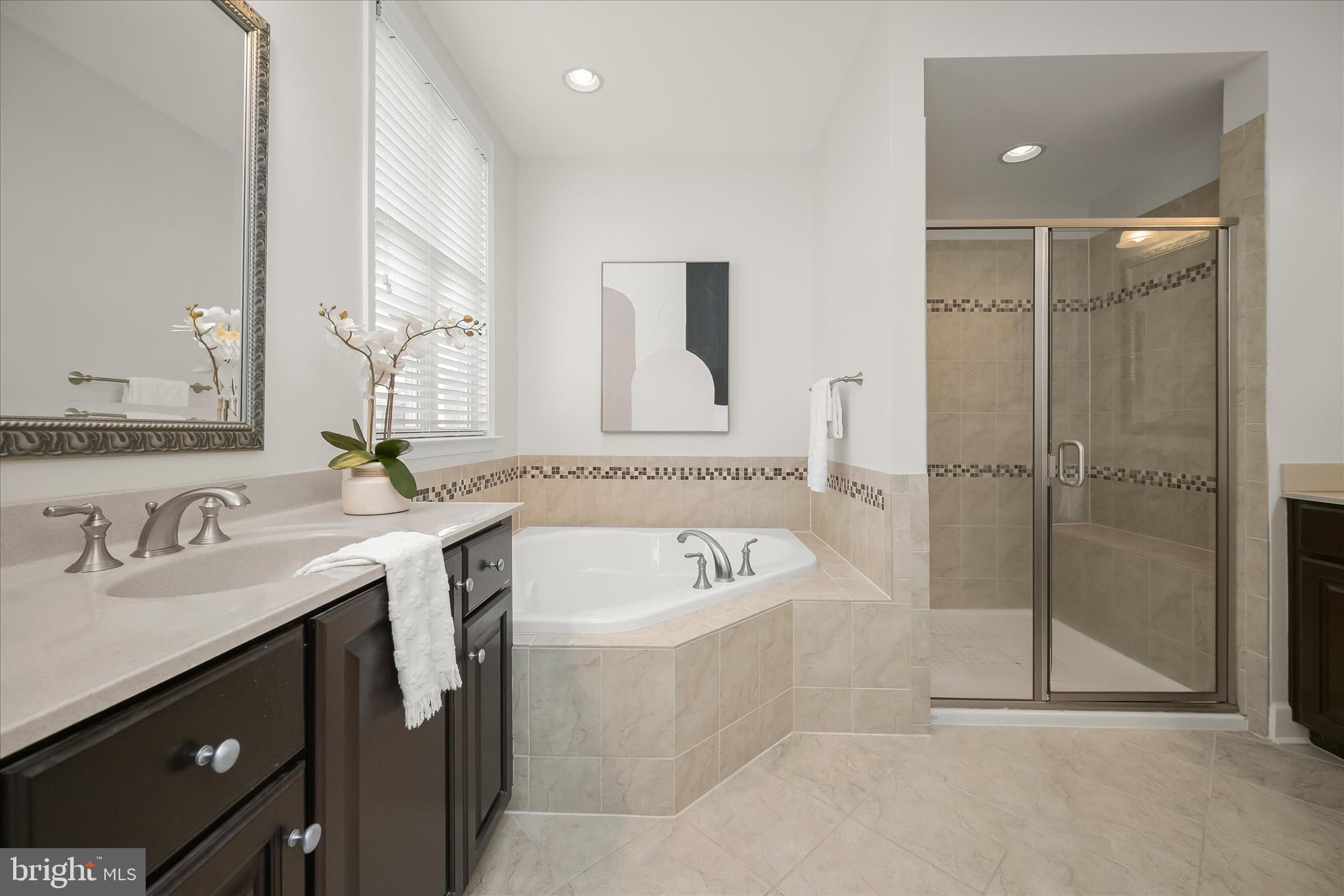 7905 Maple Lawn Boulevard Fulton, MD 20723 - Photo 24 of 49 a bathroom with a tub sink shower and mirror