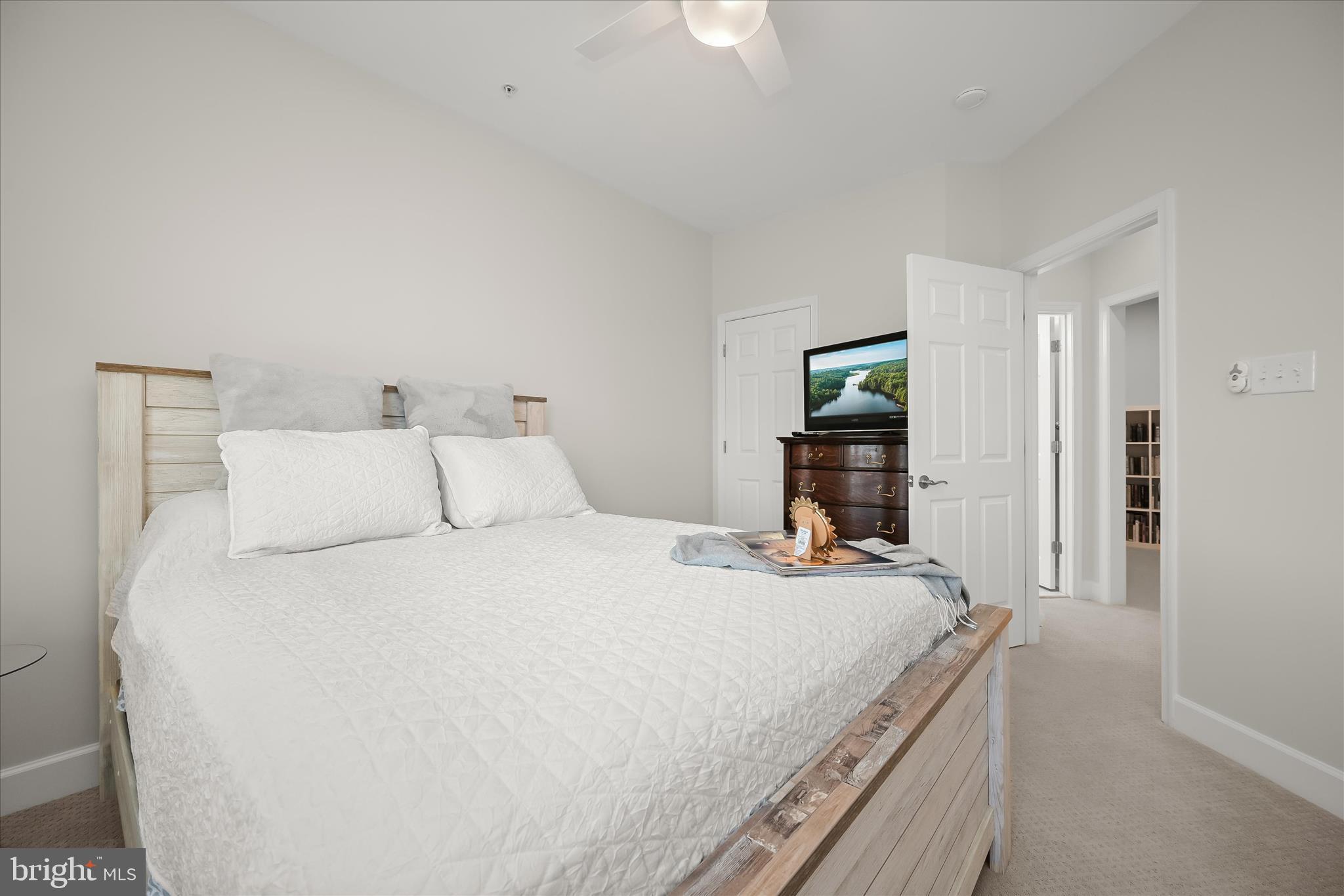 7905 Maple Lawn Boulevard Fulton, MD 20723 - Photo 29 of 49 a bedroom with a bed and a large mirror on the dresser