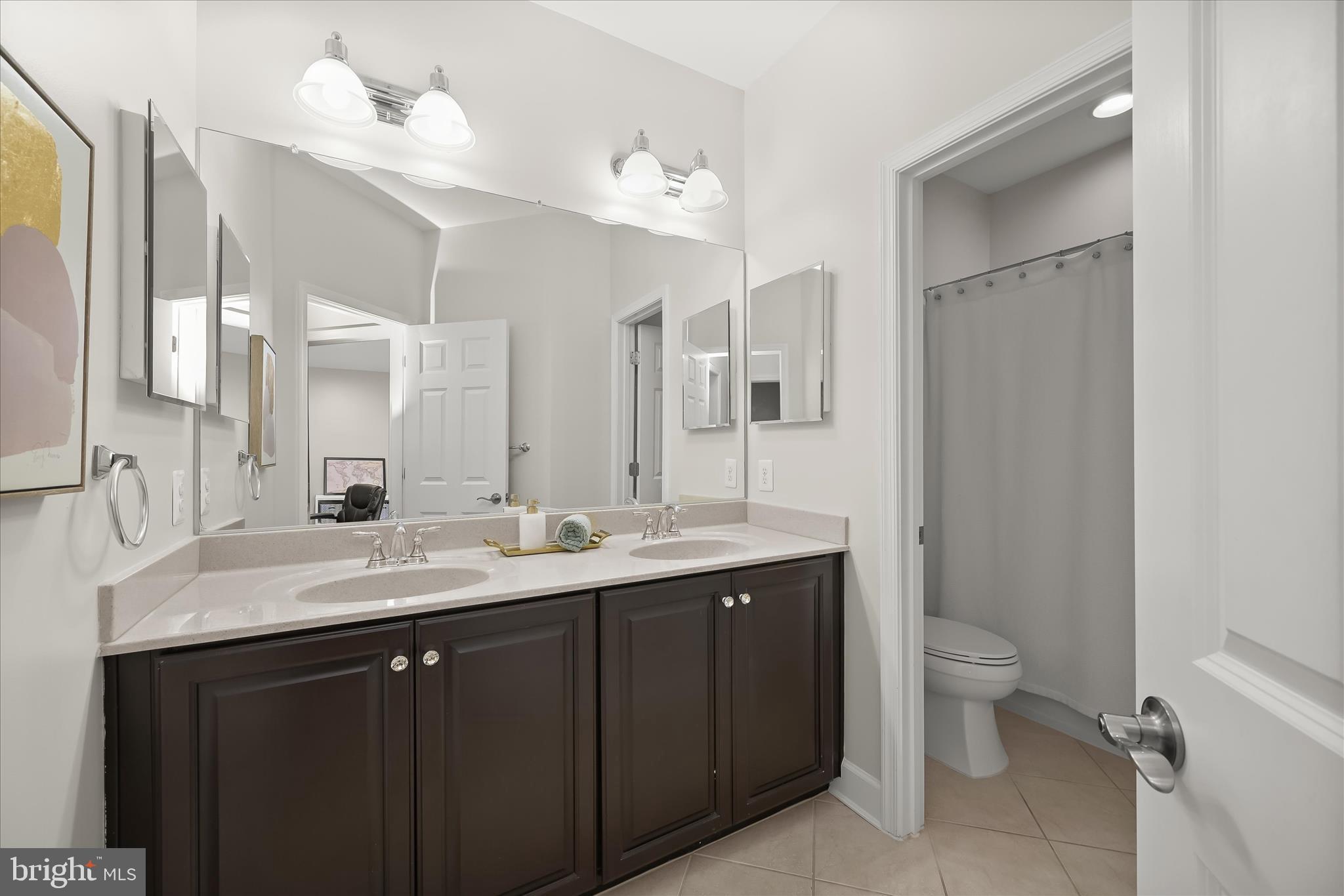 7905 Maple Lawn Boulevard Fulton, MD 20723 - Photo 30 of 49 a bathroom with a double vanity sink toilet and a mirror