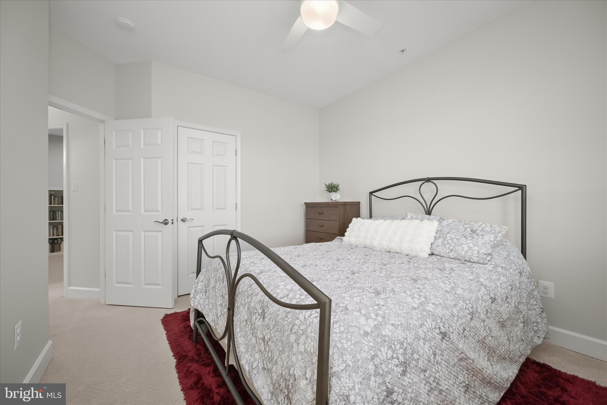 7905 Maple Lawn Boulevard Fulton, MD 20723 - Photo 32 of 49 a bedroom with a bed a window and a chandelier