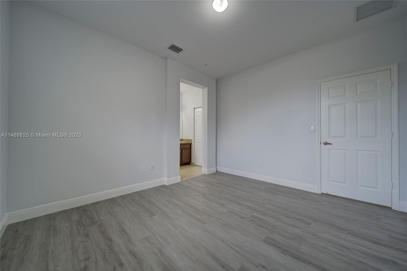 14679 Southwest 9th Street, Unit 1801 Pembroke Pines, FL 33027 - Photo 13 of 26 a view of an empty room with wooden floor