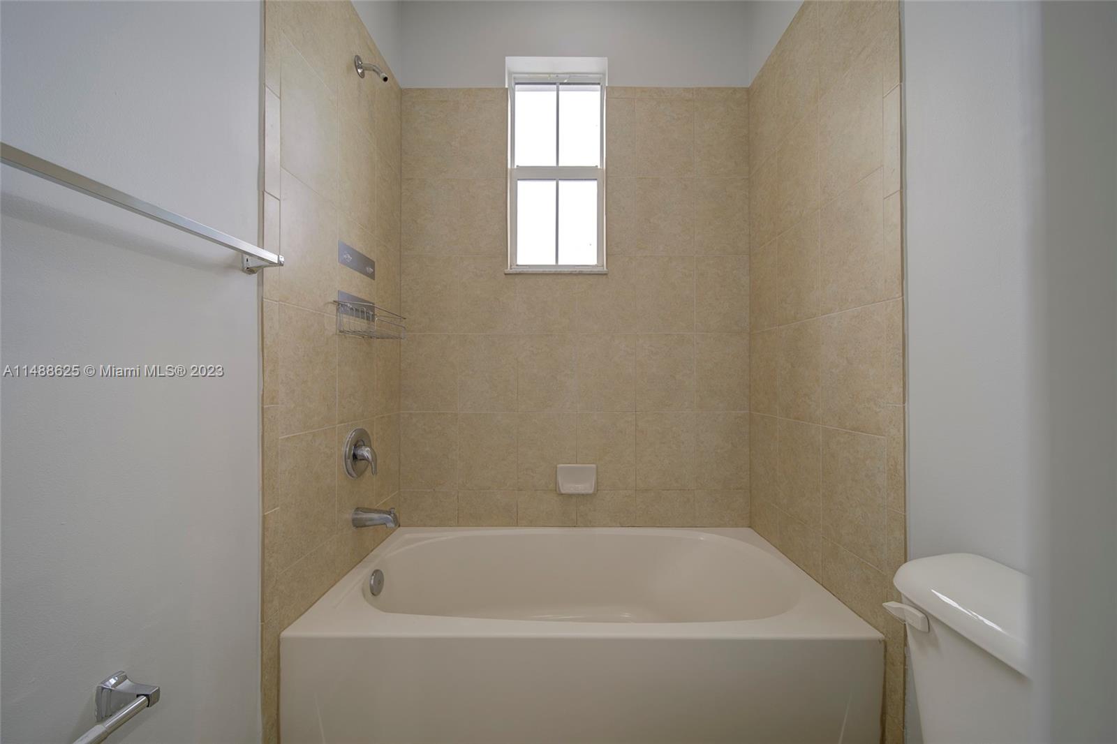 14679 Southwest 9th Street, Unit 1801 Pembroke Pines, FL 33027 - Photo 14 of 26 a bathroom with a bathtub
