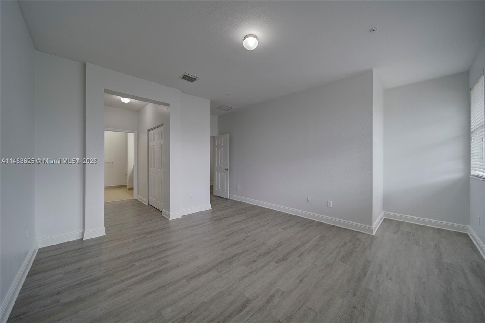 14679 Southwest 9th Street, Unit 1801 Pembroke Pines, FL 33027 - Photo 19 of 26 a view of an empty room with wooden floor