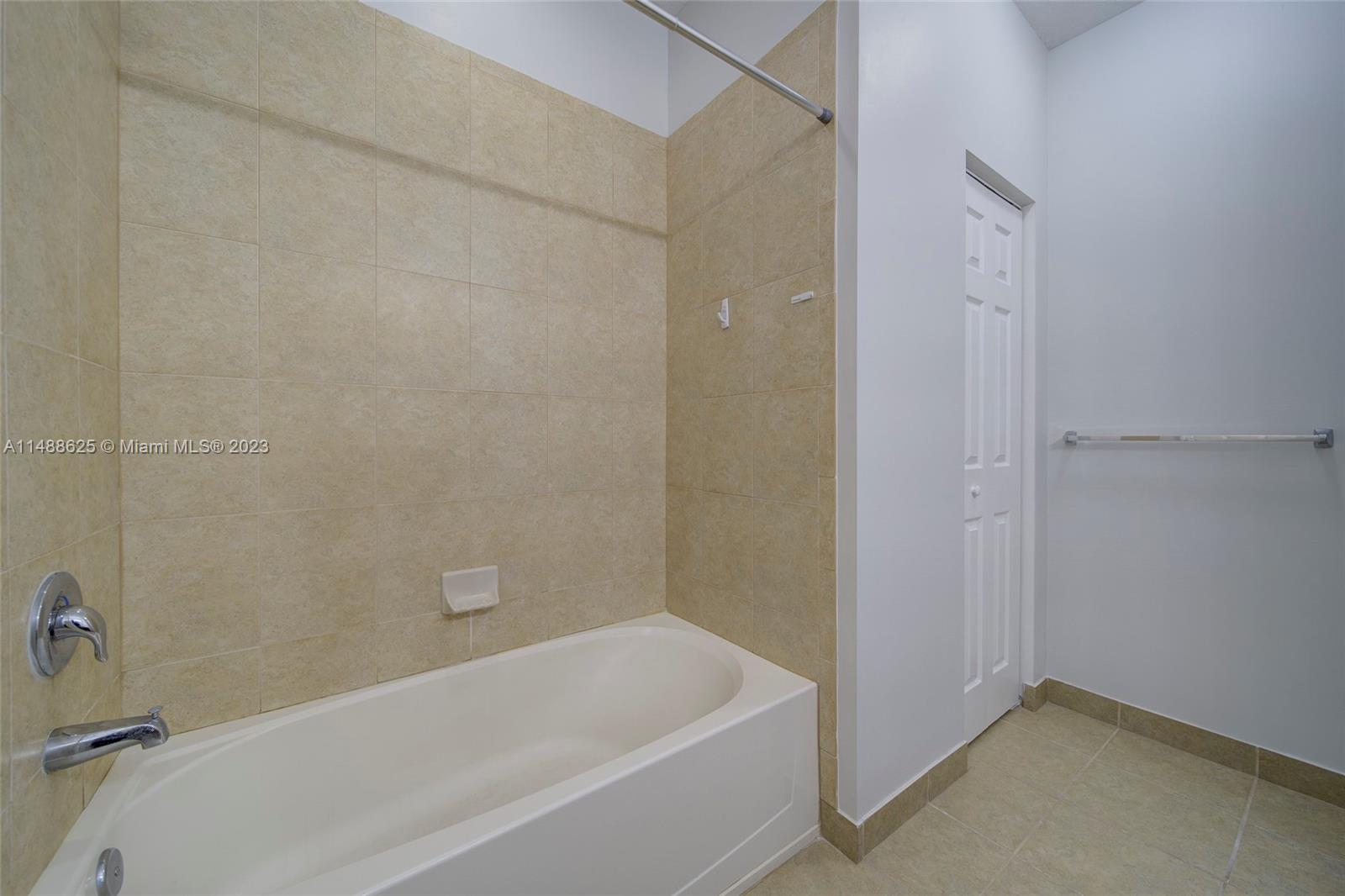 14679 Southwest 9th Street, Unit 1801 Pembroke Pines, FL 33027 - Photo 21 of 26 a bathroom with a bathtub