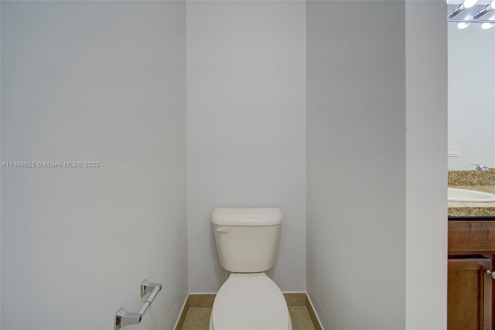 14679 Southwest 9th Street, Unit 1801 Pembroke Pines, FL 33027 - Photo 22 of 26 a bathroom with a toilet