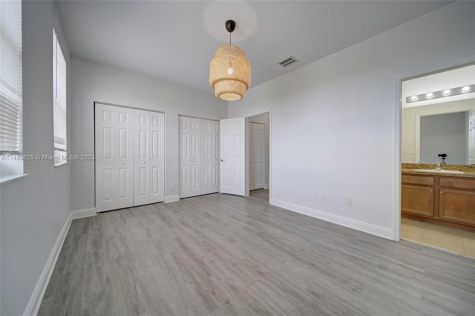 14679 Southwest 9th Street, Unit 1801 Pembroke Pines, FL 33027 - Photo 24 of 26 a view of an empty room with wooden floor and a window