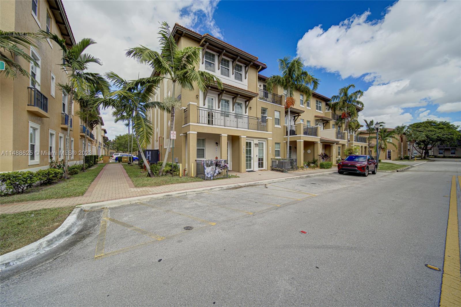 14679 Southwest 9th Street, Unit 1801 Pembroke Pines, FL 33027 - Photo 3 of 26 a cars parked on the side of a street